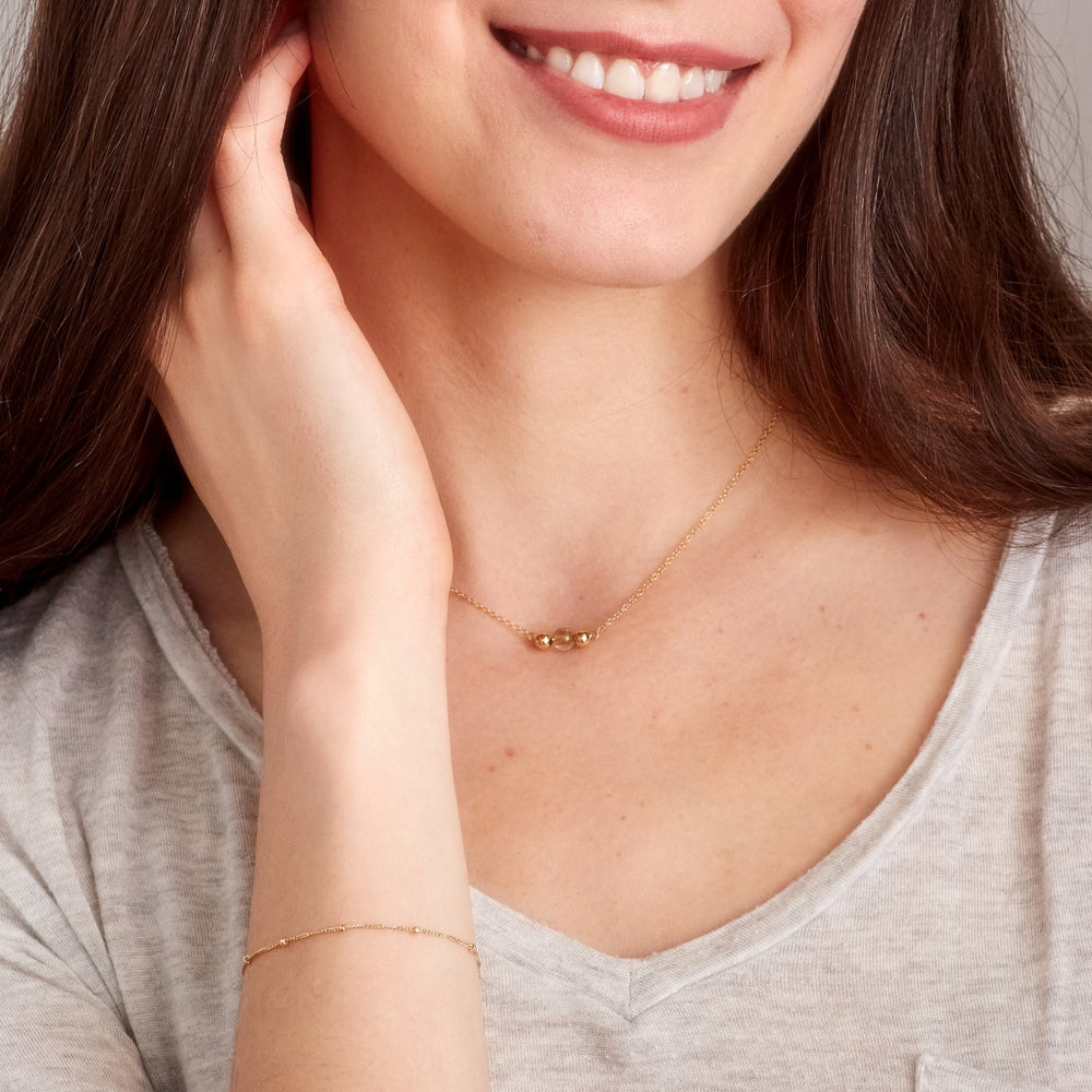 Three bead gold necklace with rutilated quartz centre bead