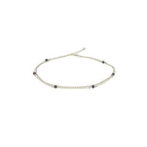 A layered silver anklet with natural sapphire gemstone beads