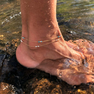 model wearing turquoise beaded and howlite beaded gold anklet 